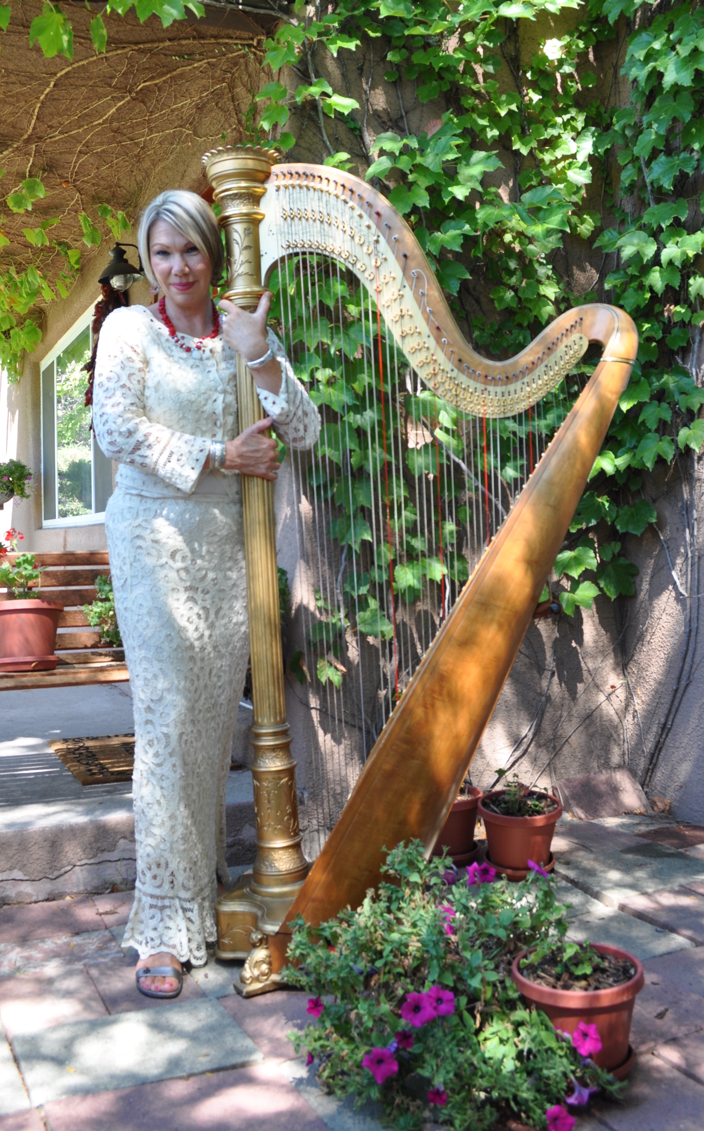 Harpist Julianne Rivera playing the harp with children